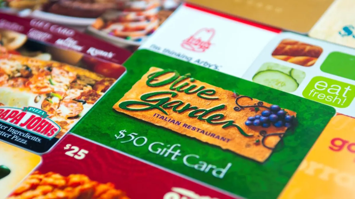 An image of various restaurant gift cards with a green Olive Garden $50 gift card in the forefront.