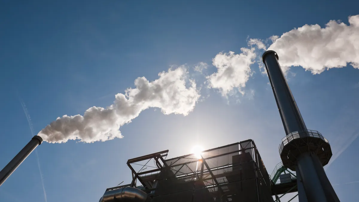 Incinerator stacks with steam and emissions coming out