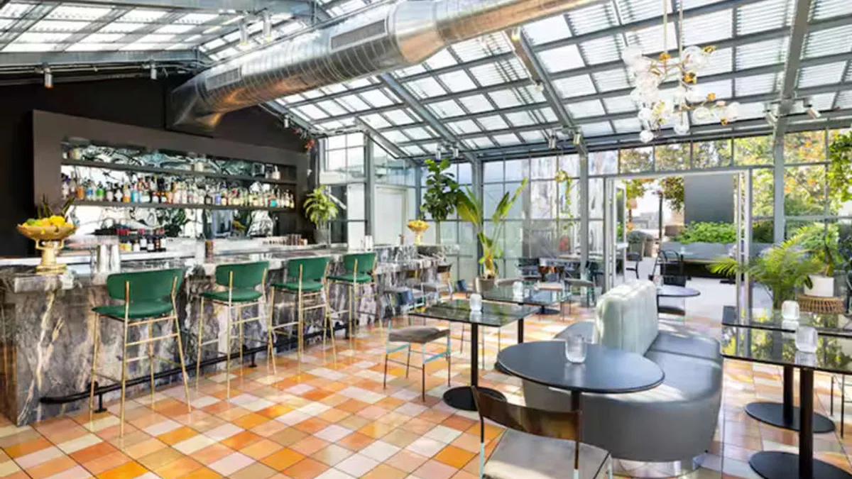 A dining area features green tiles and high chairs.