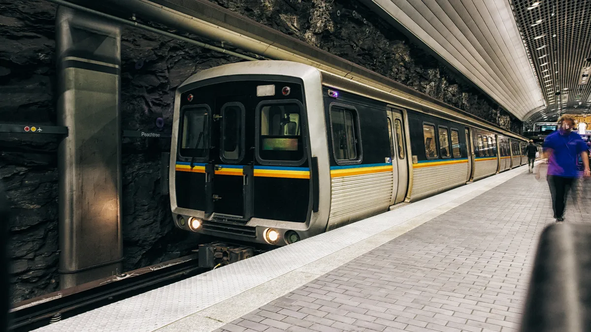 A silver and black subway train at an underground station in Atlanta.