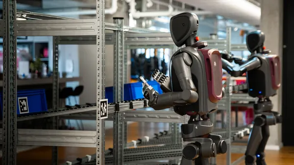 Humanoid robots work on a production line.