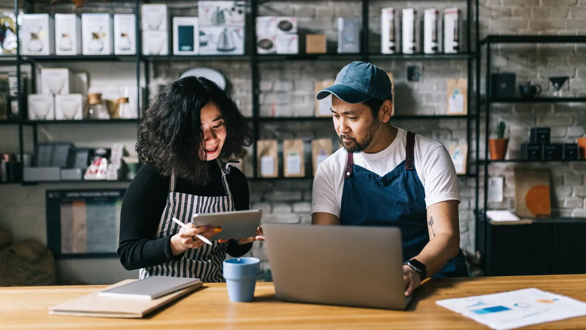 Small business owners working behind cafe counter