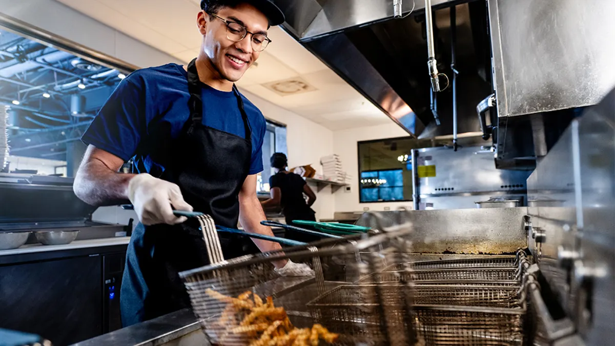 Young chef cooking in commercial kitchen