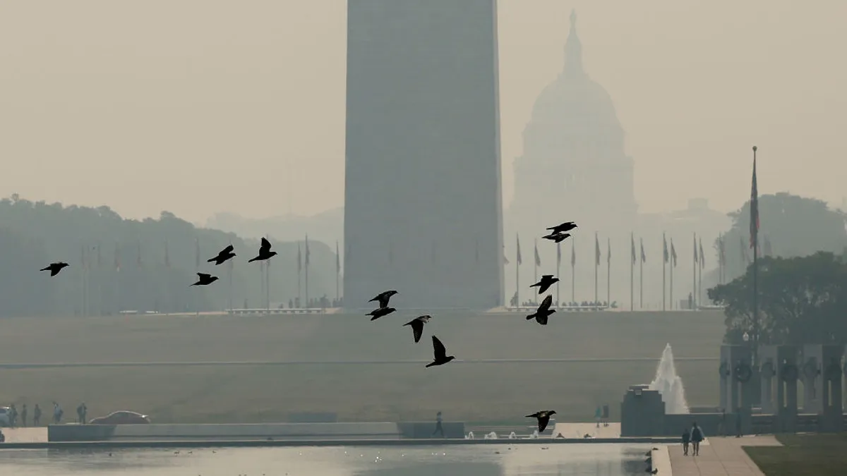 Wildfire smoke casts a haze over the National Mall.