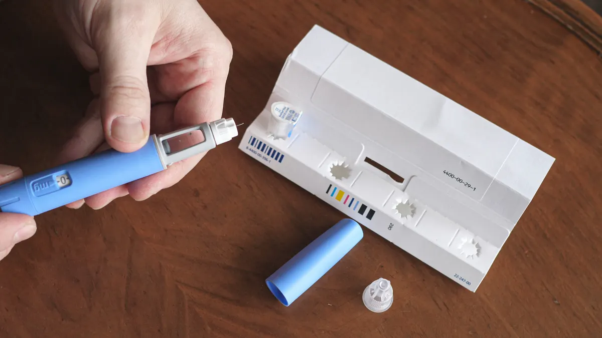 A person with obesity prepares a drug for injection.