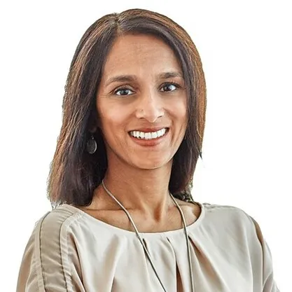 Headshot of a woman with caramel skin and long brown hair.