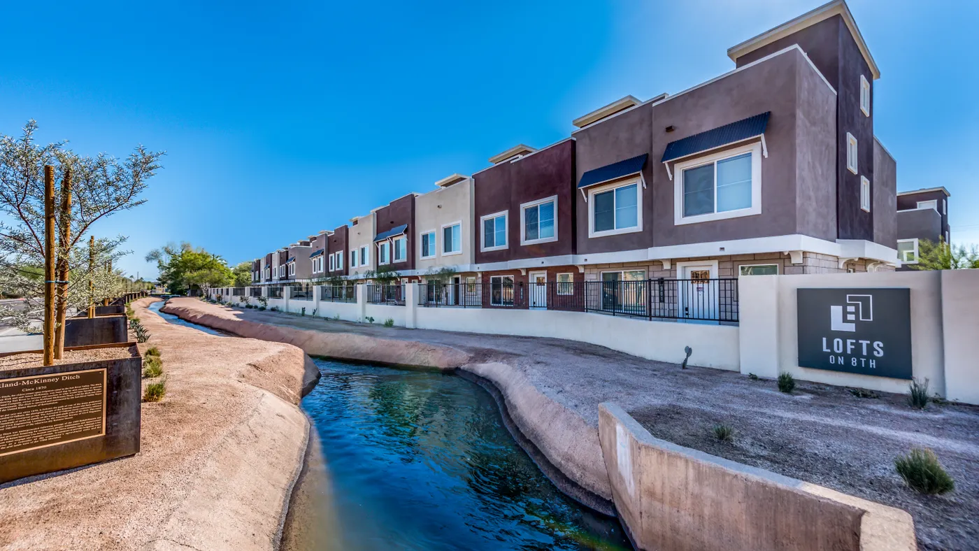 Student housing with a canal in the foreground.