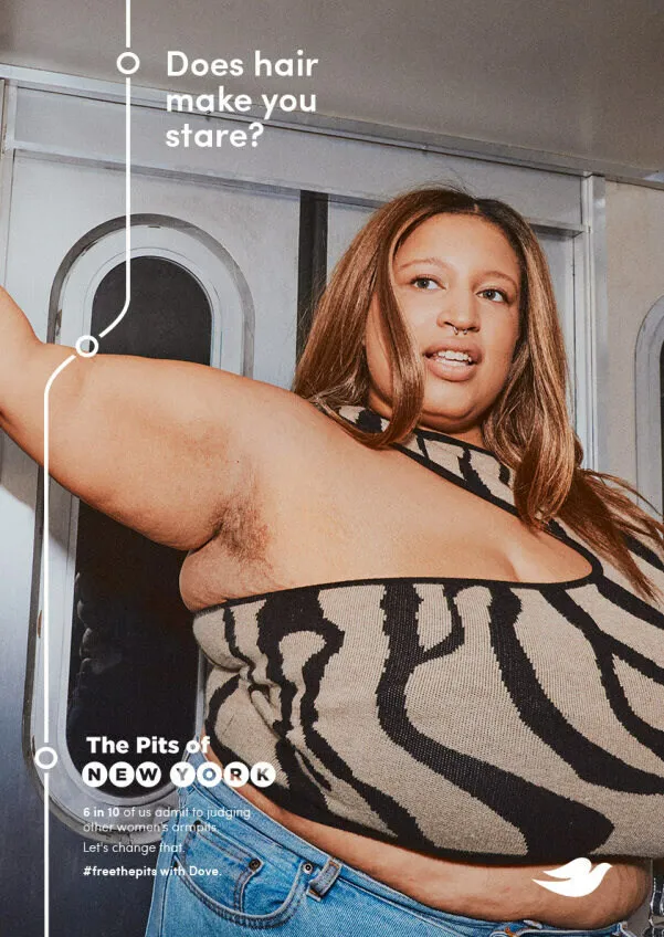 A person stands on a New York City Subway car and shows off their armpits for a Dove campaign