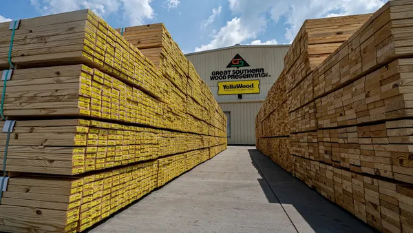 High stacks of lumber outside a lumber facility.