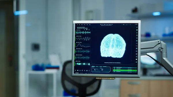 A brain scan is seen on a computer screen in an empty medical laboratory.