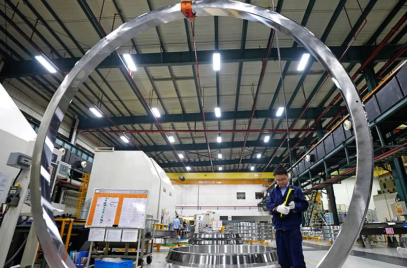 A large bore bearing dwarfs a worker at Timken’s Xiangtan, China, plant.