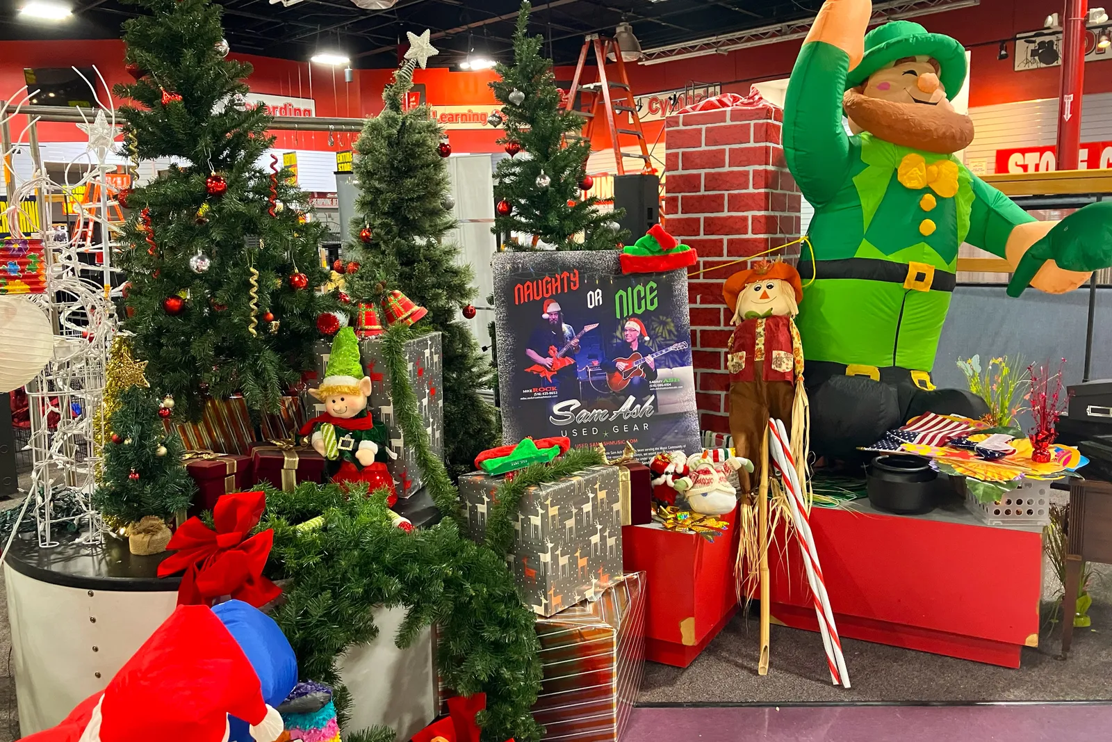 A collection of holiday decorations, including artificial Christmas trees and an inflatable St. Patrick, are offered for sale.