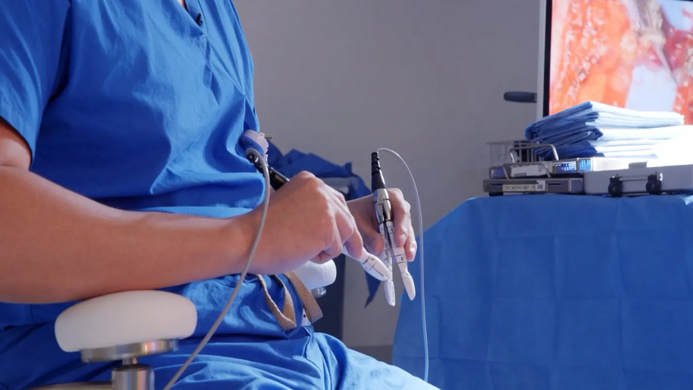 The handheld controllers of MMI's Symani robot are demonstrated.