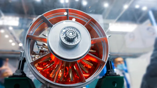 The front of a plane turbine engine with red on its inside.