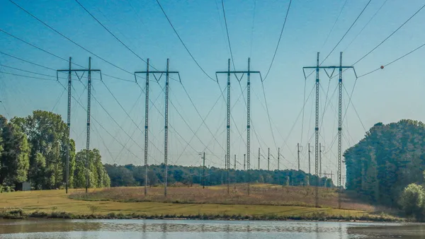 Electric power lines cross a body of water.