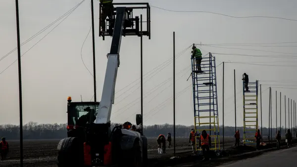 Workers install anti-drone netting on the roads in Druzhkivka, Ukraine.