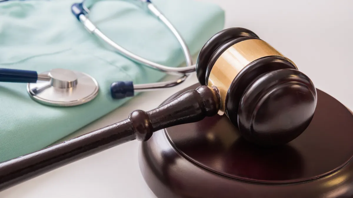 Gavel and stethoscope in background