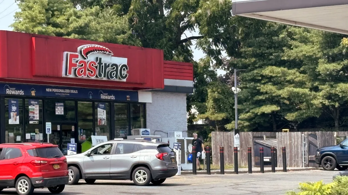 A photo of the exterior of a gas station and convenience store. A sign on the store says Fastrac.