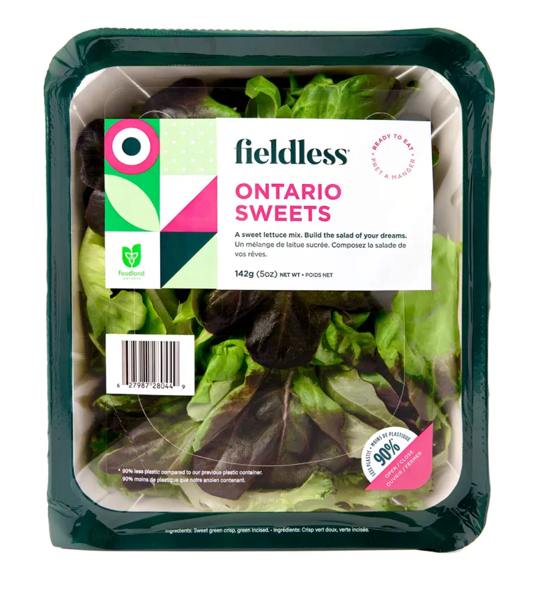 A package of Fieldless brand lettuce in a fiber base container with plastic film lid.