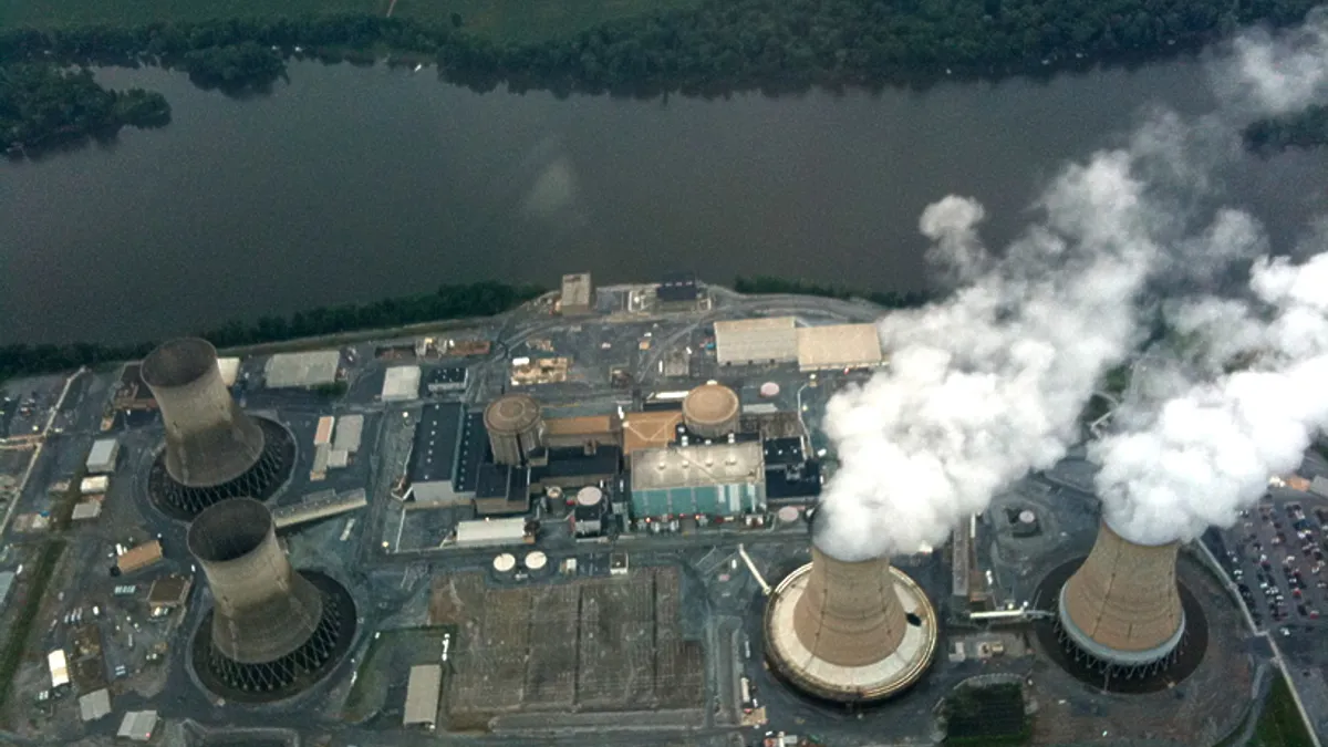 An aerial view of a nuclear power plant next to a river.