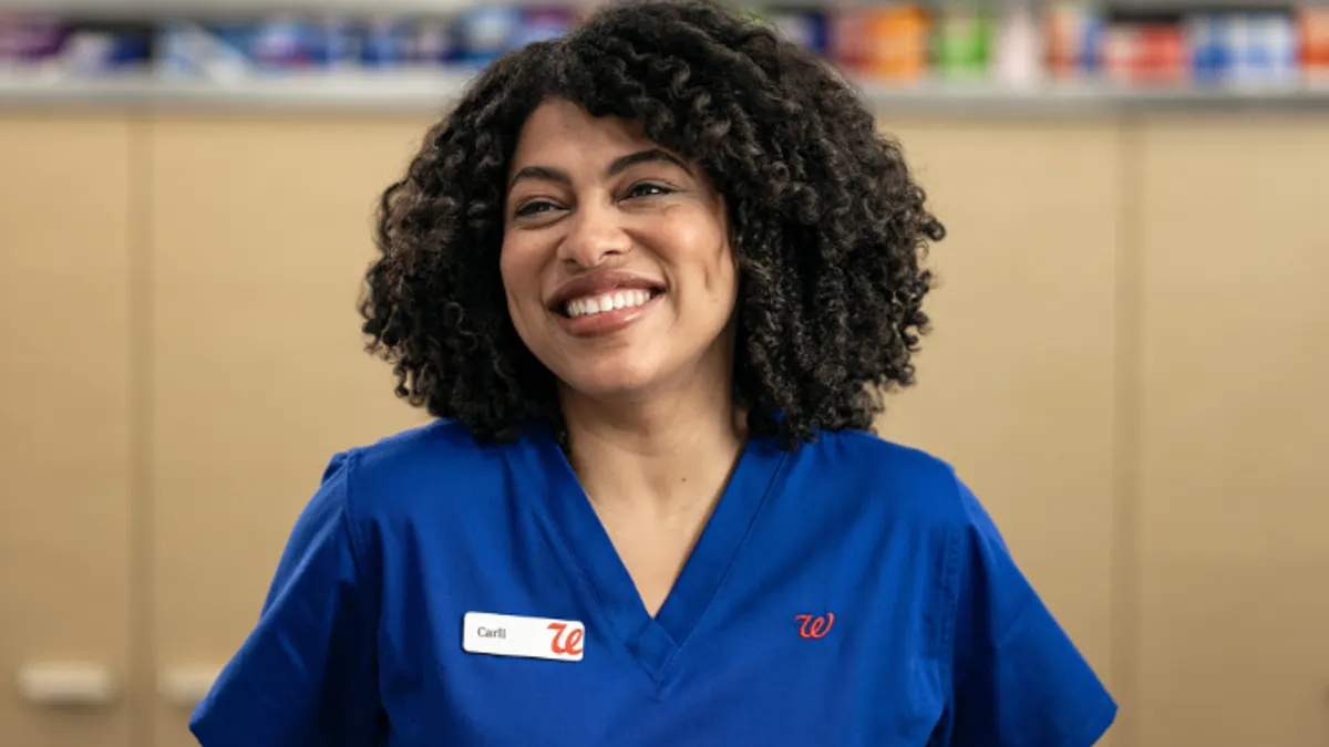 Nurse in blue apron.