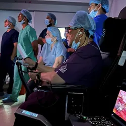 A surgeon performs a telerobotic surgery.