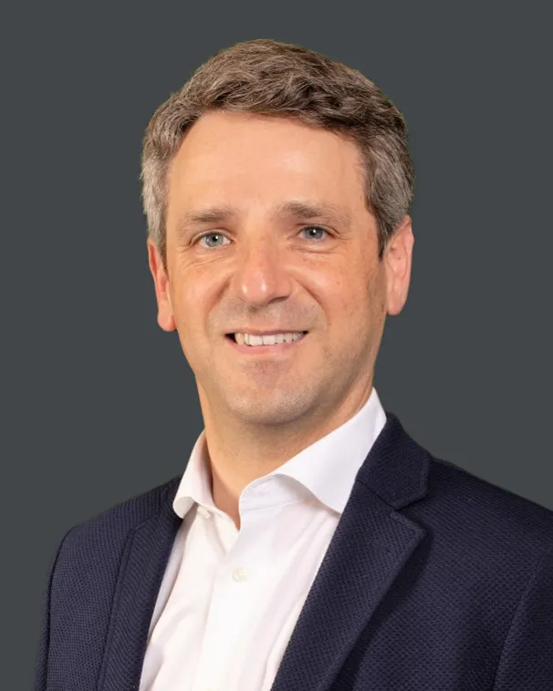Headshot of a man in a suit.