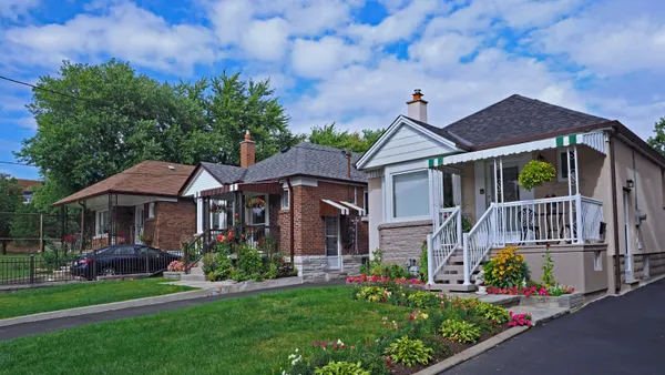 Street with row of modest 1950s style working class bungalows