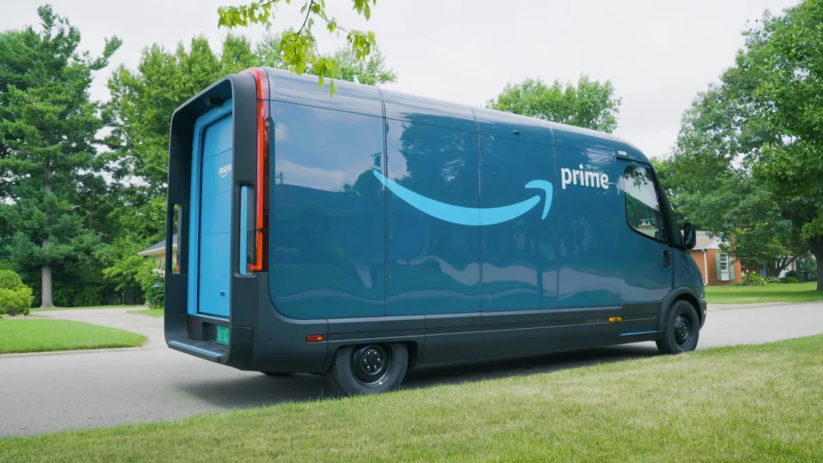 An Amazon delivery van made by Rivian sits in a neighborhood.