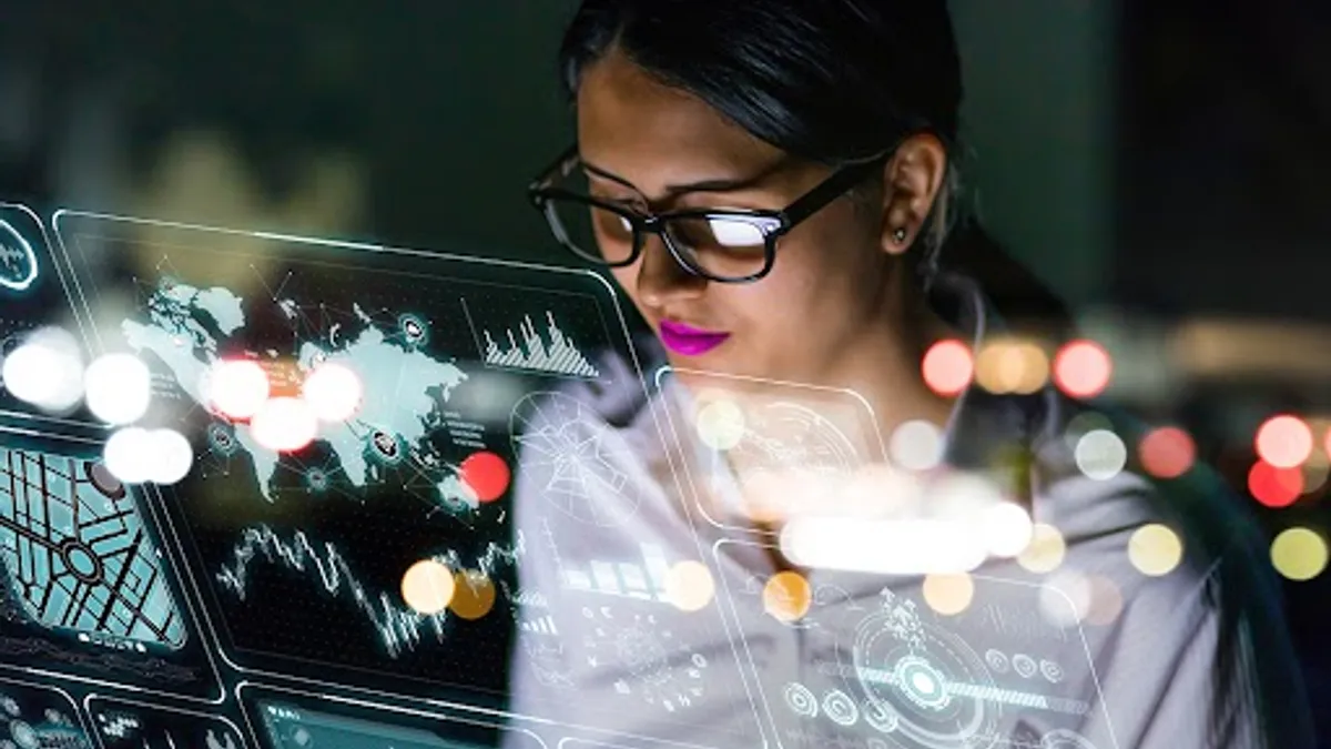 Businesswoman looking at futuristic interface screen.