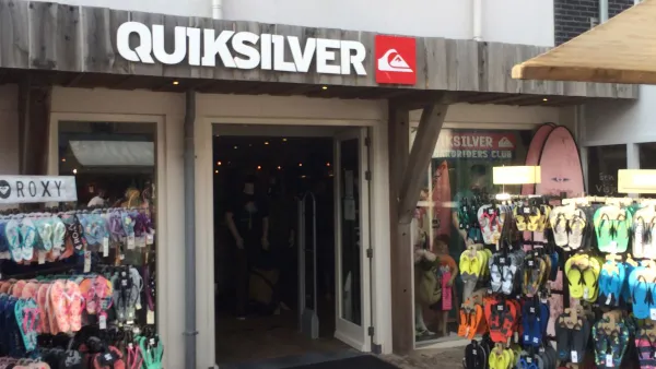 A Quiksilver storefront, with racks of flip flops outside.