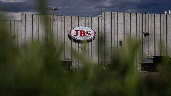 The outside of a building is seen with the JBS logo