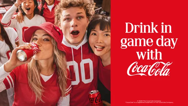 A group of college football fans stand in a stadium bearing expressions of awe as part of Coke’s latest “Fan Work Is Thirsty Work” campaign