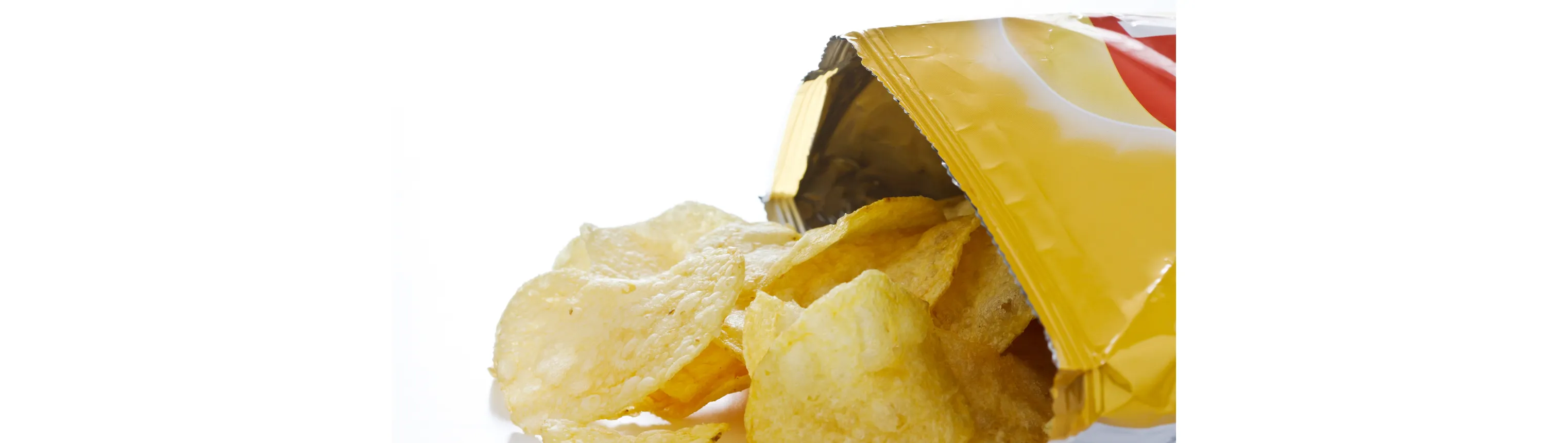 Side view of a bag of open potato chips, with chips spilling out