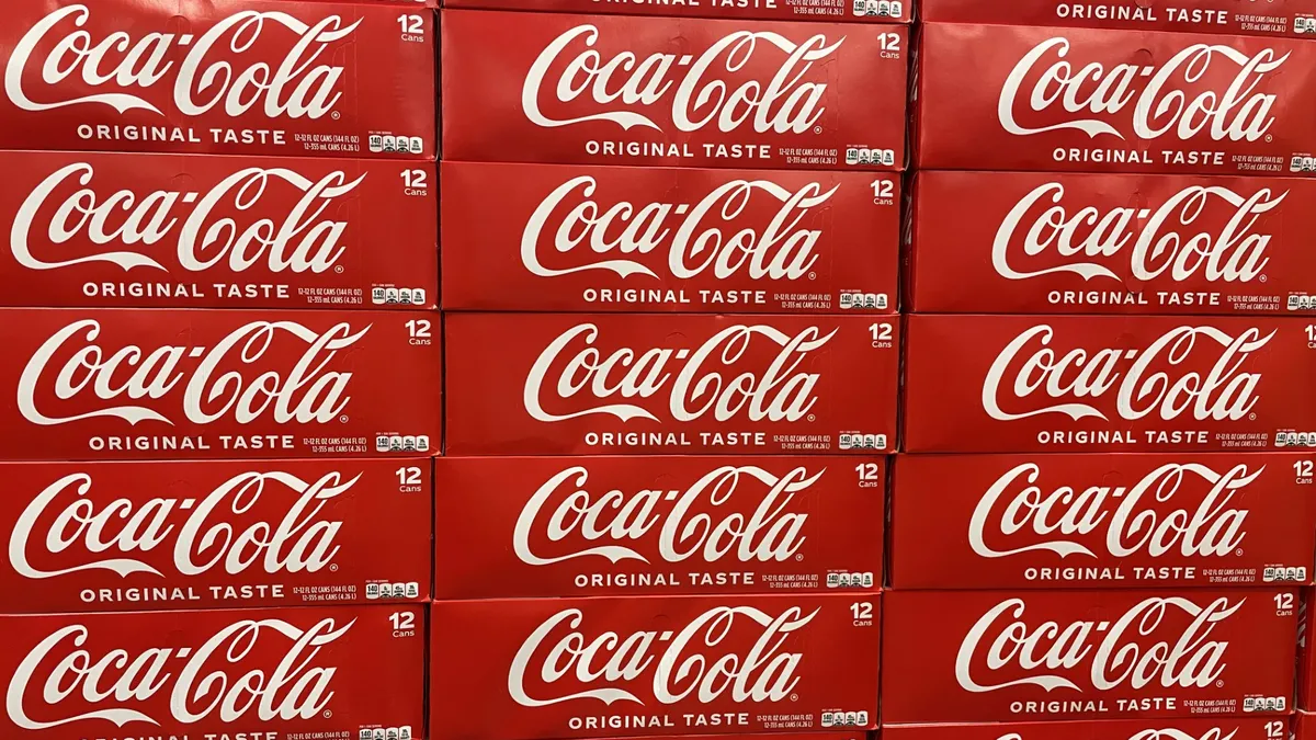 Boxes of Coca-Cola in a grocery store.