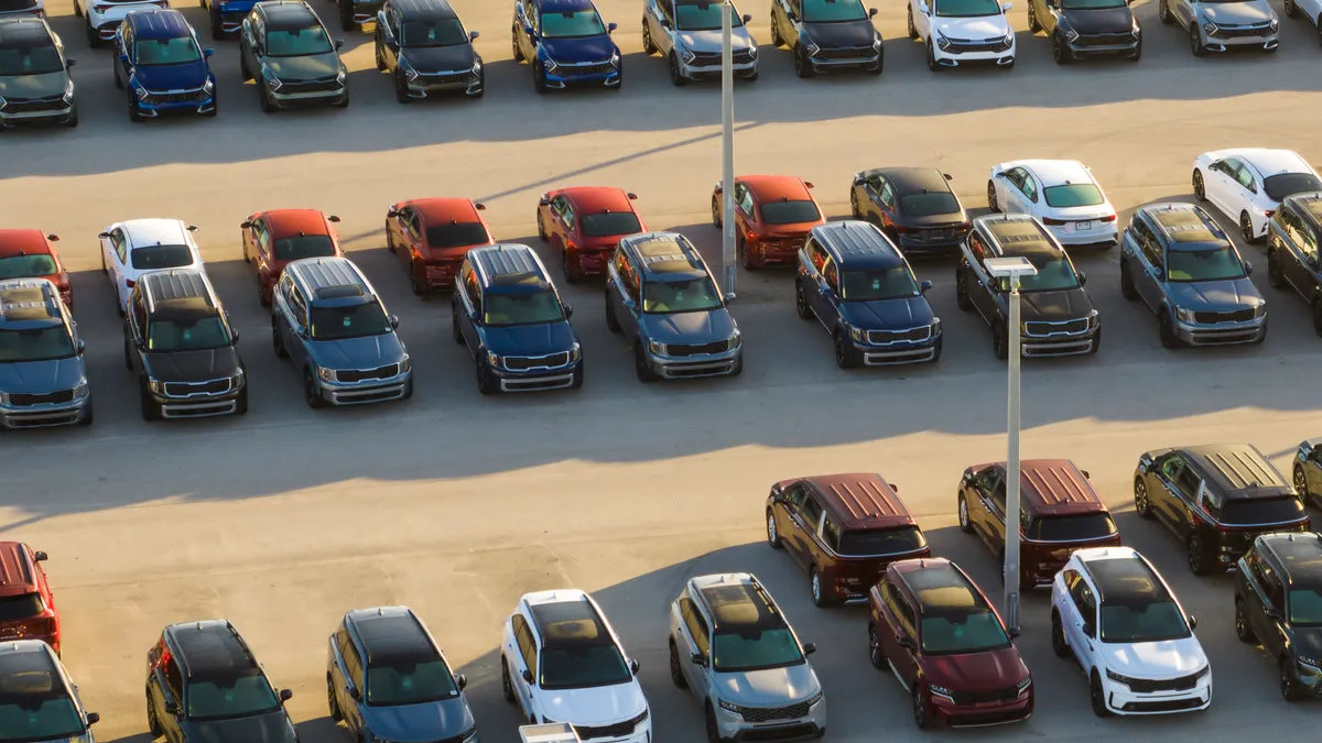 New cars parked at a dealership.