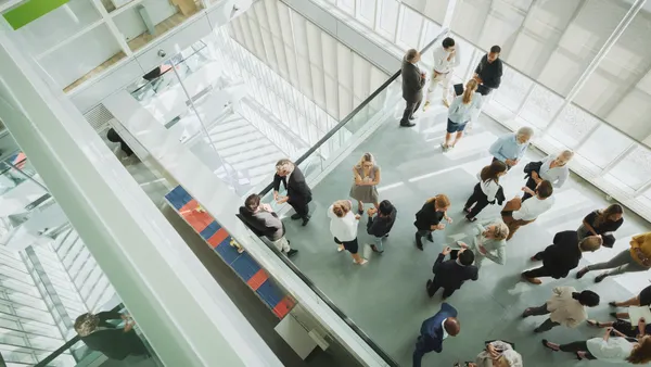 A view from up of a floor of a busy conference center.
