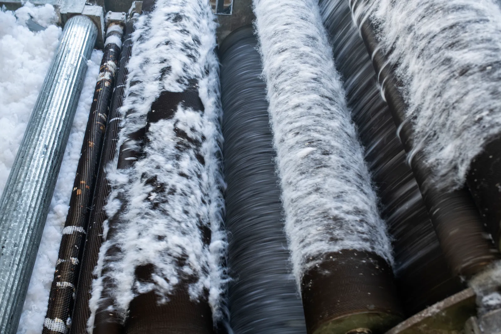 Fibers on rollers in a factory.