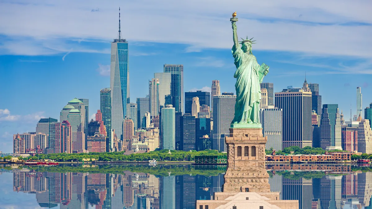 View of the Statue of Liberty in front of the New York City Skyline