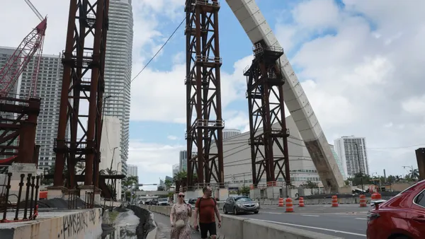 Concrete arches rise above the Signature Bridge construction project