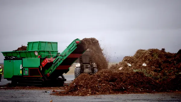 Conveyor processing compost at a landfill from consumer collection program