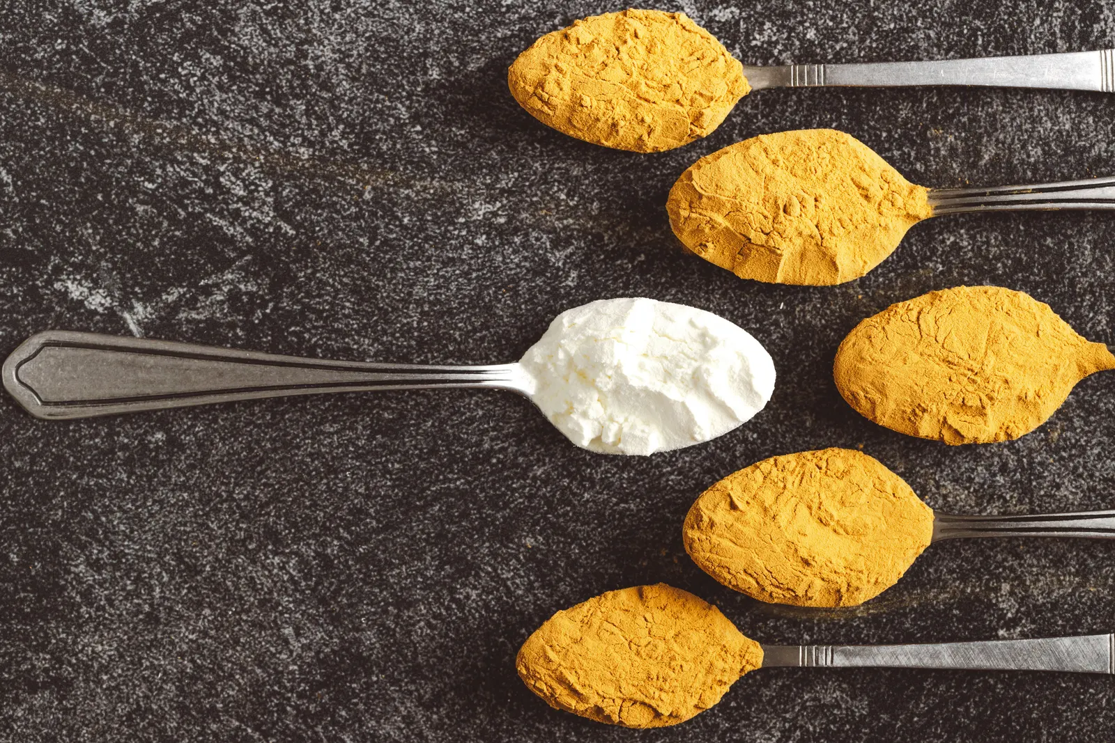 Three metal spoons with powder solution on them