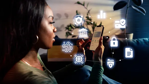 Woman with digital card with business icons overlay.