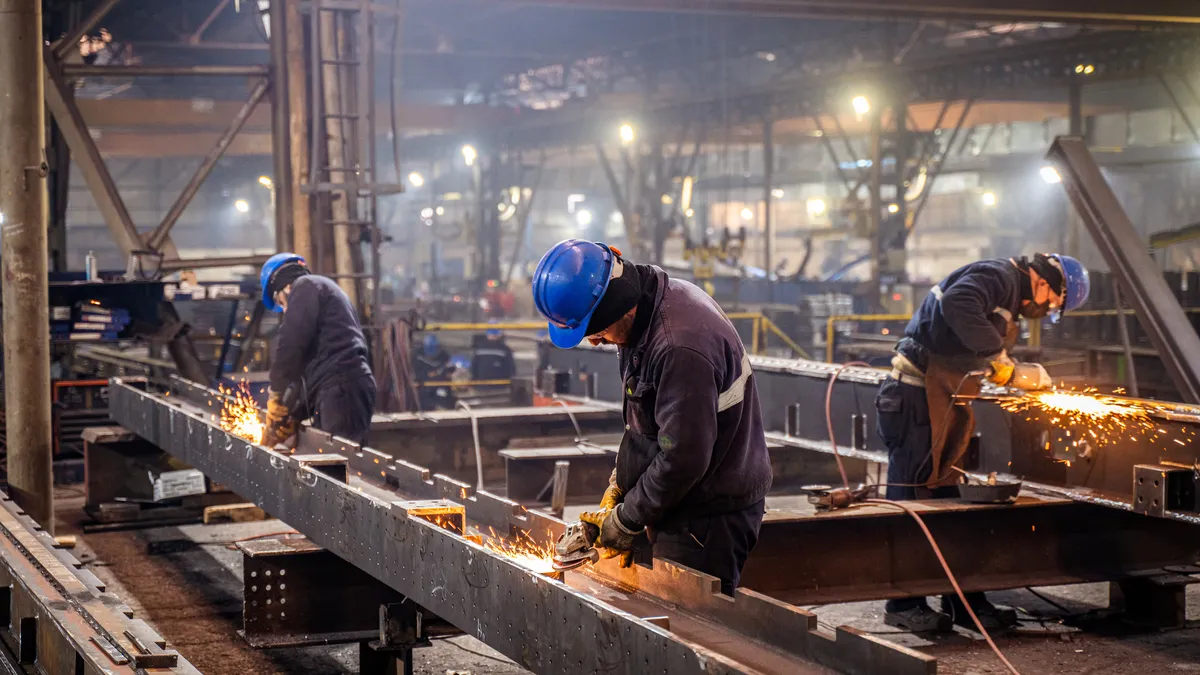 Workers in a factory for metal production.