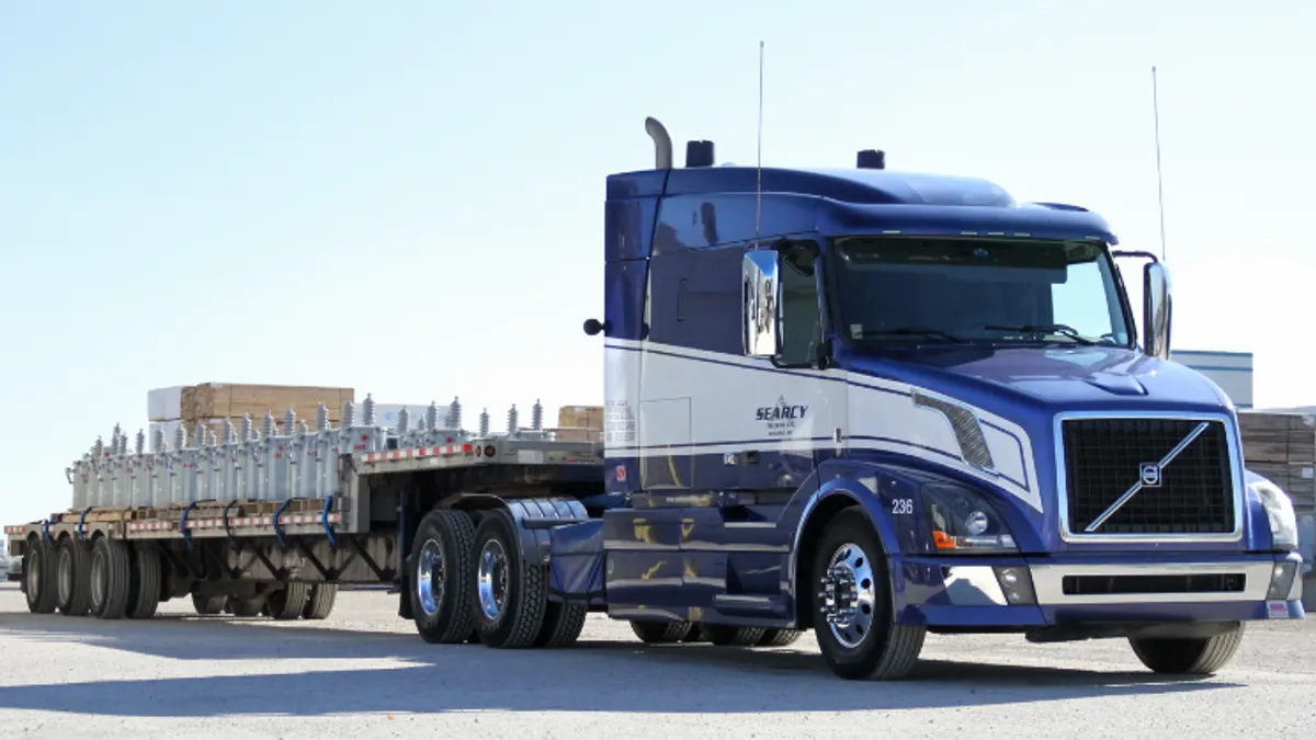 A blue and silver truck with the Searcy Trucking logo.