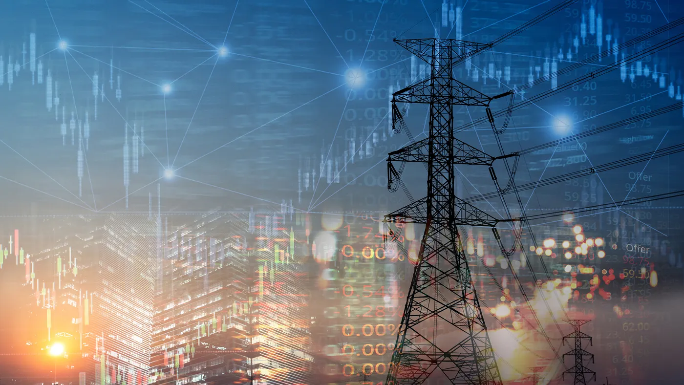 Electric power lines with a cityscape and stock market data graphics overlayed at sunset.