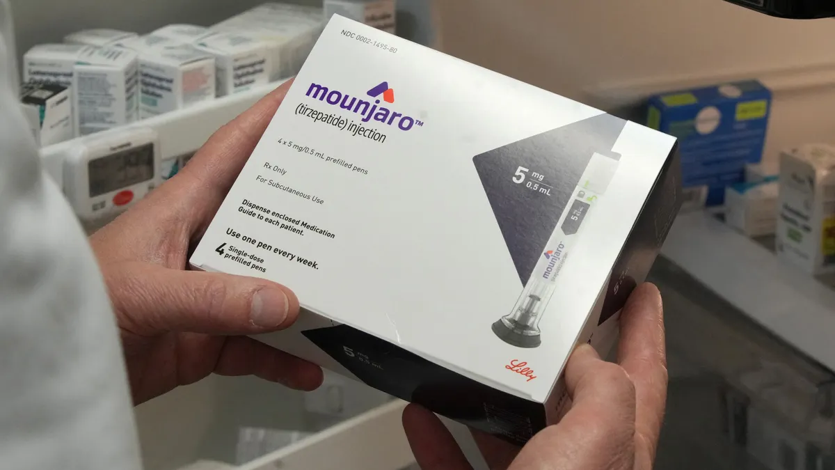 A box of Eli Lilly's diabetes drug Mounjaro is held for a photo.