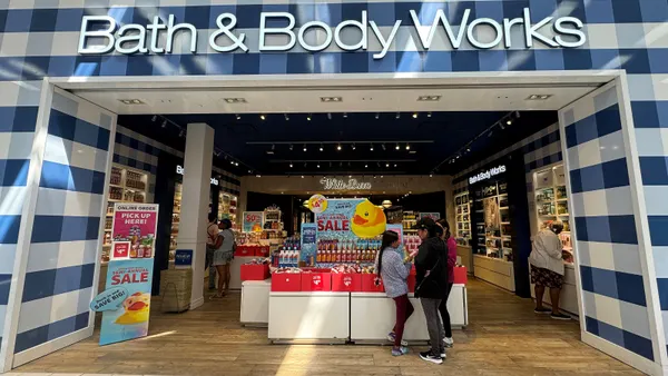 Two customers look at a display at a Bath & Body Works store.