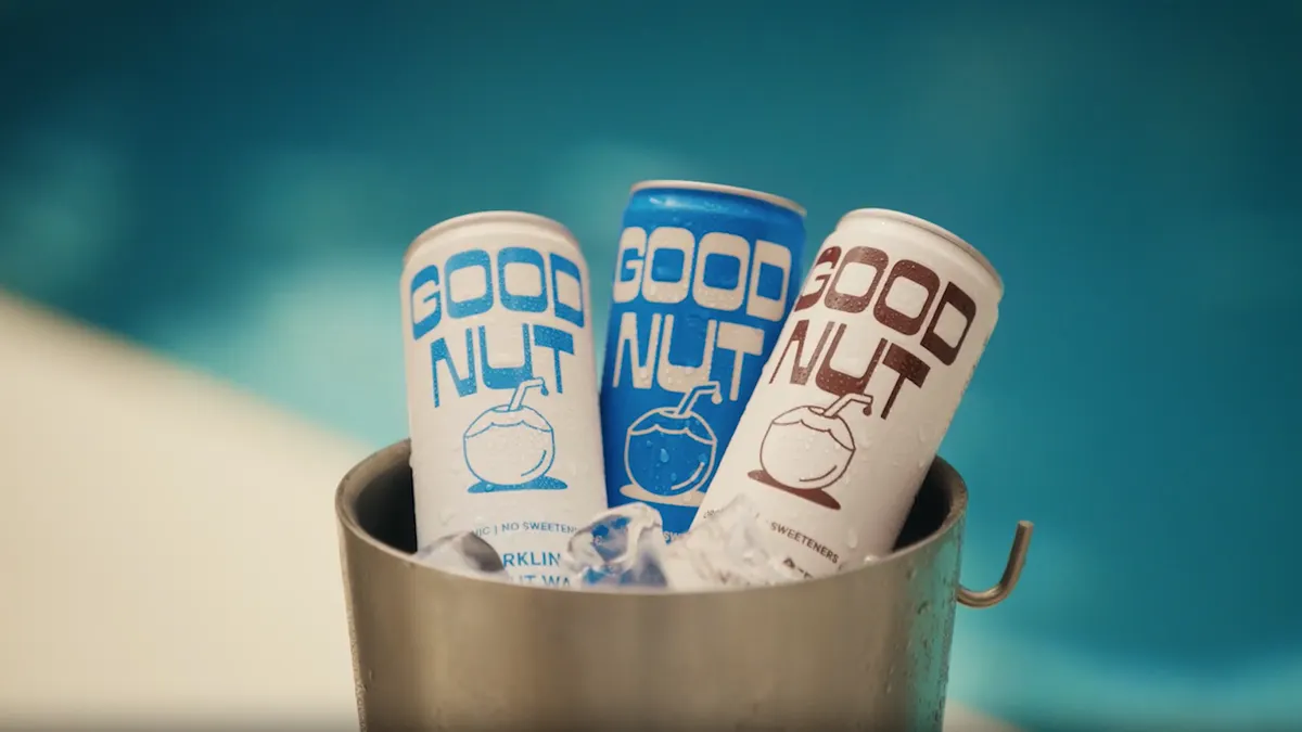 Three cans of Good Nut sit poolside.