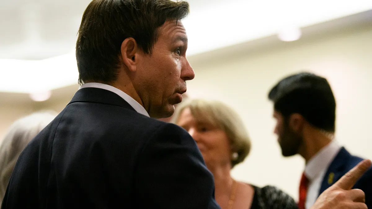 Close-up image of Ron DeSantis in profile with his finger outstretched